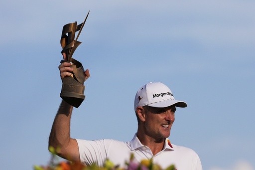 Justin Rose, of England, holds the trophy after winning the St. Jude Championship golf tournament Sunday, Aug. 10, 2025, in Memphis, Tenn. (AP Photo/George Walker IV)
