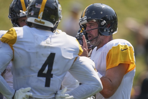 Pittsburgh Steelers quarterback Aaron Rodgers, right, calls a play in the huddle during practice at NFL football training camp in Latrobe, Pa., Wednesday, July 30, 2025. (AP Photo/Gene J. Puskar)