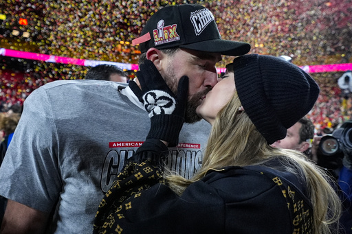 FILE - Kansas City Chiefs tight end Travis Kelce and Taylor Swift kiss after the AFC Championship NFL football game against the Buffalo Bills, Jan. 26, 2025, in Kansas City, Mo. (AP Photo/Ashley Landis, File)