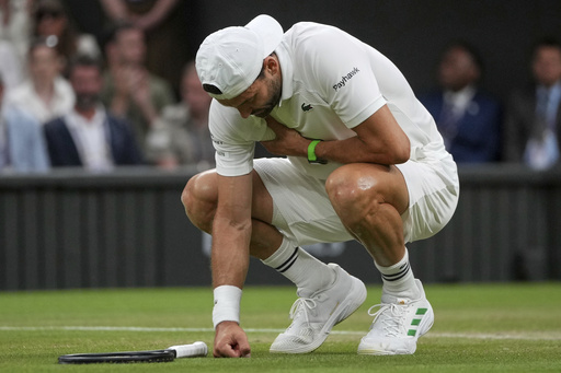 FILE - Bulgaria's Grigor Dimitrov clutches his chest with an injury which forced him to retire injured from a fourth round men's singles match against Italy's Jannik Sinner at the Wimbledon Tennis Championships in London, Monday, July 7, 2025. (AP Photo/Kin Cheung, file)