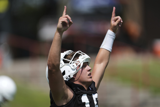 Texas quarterback Arch Manning (16) reacts during an NCAA college football practice in Austin, Texas, Wednesday, July 30, 2025. (AP Photo/Eric Gay)