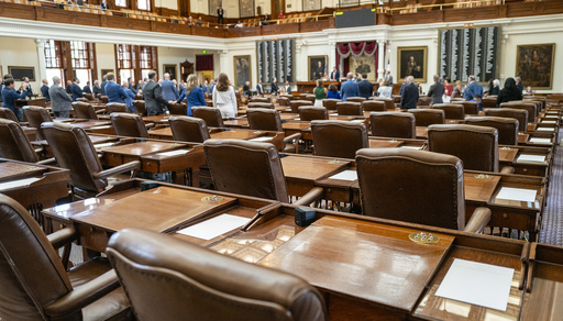 Empty chairs belonging to Texas House Representatives remain empty as House Republicans conduct business on the floor of the Texas Capitol, Friday, Aug. 8, 2025, in Austin, Texas. (AP Photo/Rodolfo Gonzalez)