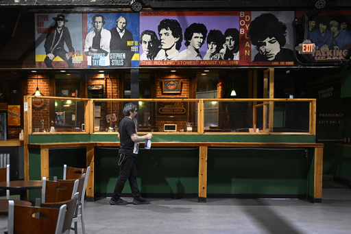 A mural of past concerts at Toad's Place is displayed above one of the bars in New Haven, Conn., on Friday, May 9, 2025. (AP Photo/Jessica Hill)