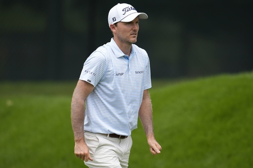 Russell Henley walks on the first fairway during the first round of the Tour Championship golf tournament, Thursday, Aug. 21, 2025, in Atlanta. (AP Photo/Mike Stewart)
