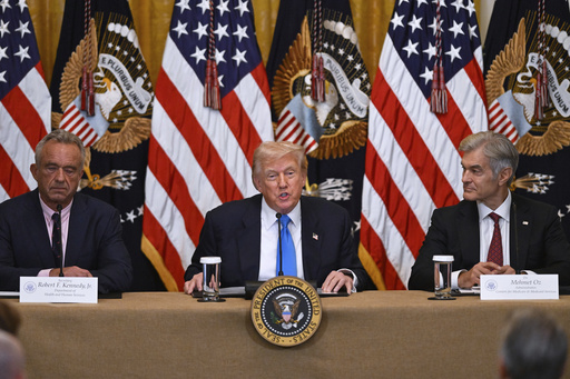 President Donald Trump speaks at an event to promote his proposal to improve Americans' access to their medical records, in the East Room of the White House, Wednesday, July 30, 2025, in Washington, as Health and Human Service Secretary Robert F. Kennedy, Jr., left, and Administrator of the Centers for Medicare and Medicaid Services, Mehmet Oz, right, look on. (AP Photo/John McDonnell)