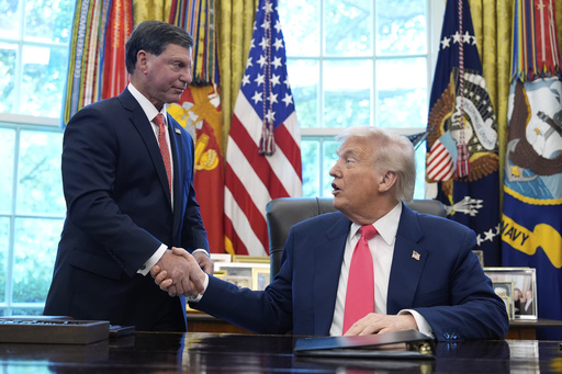 President Donald Trump, right, shakes the hand of Social Security Commissioner Frank Bisignano during an event in the Oval Office to mark the 90th anniversary of the Social Security Act, Thursday, Aug. 14, 2025, in Washington. (AP Photo/Alex Brandon)
