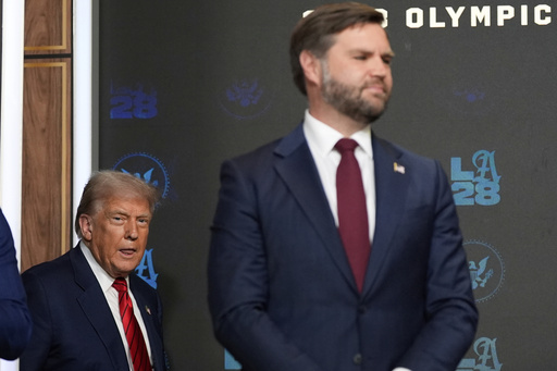 President Donald Trump arrives to speak before signing an executive order about the 2028 Los Angeles Olympic Games, in the South Court Auditorium of the Eisenhower Executive Office Building on the White House campus, Tuesday, Aug. 5, 2025, in Washington, as Vice President JD Vance watches. (AP Photo/Alex Brandon)