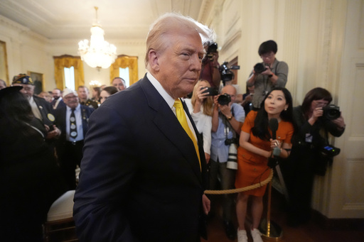 President Donald Trump departs an event to mark National Purple Heart Day in the East Room of the White House, Thursday, Aug. 7, 2025, in Washington. (AP Photo/Mark Schiefelbein)