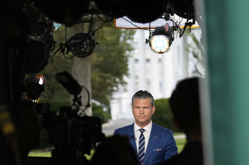 Defense Secretary Pete Hegseth prepares to give a television interview outside the White House Thursday, Aug. 7, 2025, in Washington. (AP Photo/Mark Schiefelbein)