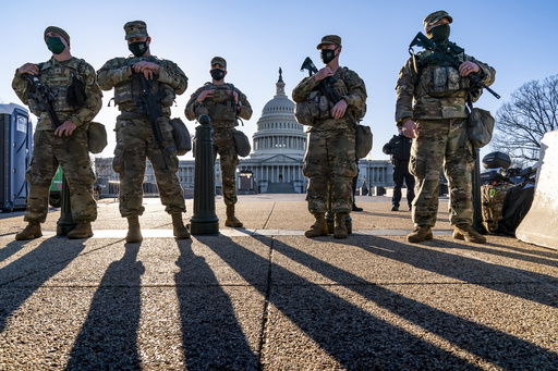 FILE - National Guard troops and the U.S. Capitol Police keep watch as heightened security remains in effect around the Capitol grounds in Washington, March 3, 2021. (AP Photo/J. Scott Applewhite, File)