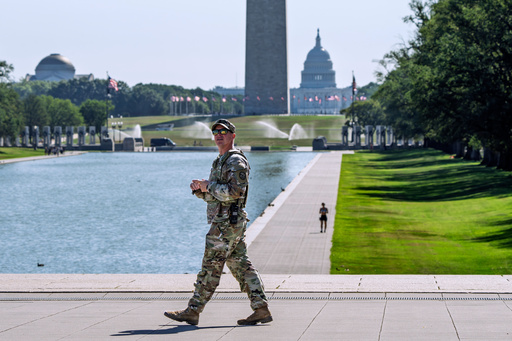 A member of the West Virginia National Guard gazes up at the Lincoln Memorial on the National Mall in Washington, as part of President Donald Trump's order to use federal law enforcement to expel homeless people and rid the nation's capital of violent crime, Monday, Aug. 25, 2025. (AP Photo/J. Scott Applewhite)