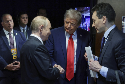 U.S. President Donald Trump, second right, shakes hands with Russian President Vladimir Putin after their joint news conference on Friday, Aug. 15, 2025, at Joint Base Elmendorf-Richardson, Alaska. ((Gavriil Grigorov, Sputnik, Kremlin Pool Photo via AP)
