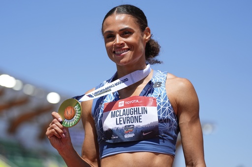 Sydney McLaughlin-Levrone shows her gold medal after winning the women's 400-meter finals during the U.S. Championships athletics meet in Eugene, Ore.,Saturday, Aug. 2, 2025. (AP Photo/Ashley Landis)
