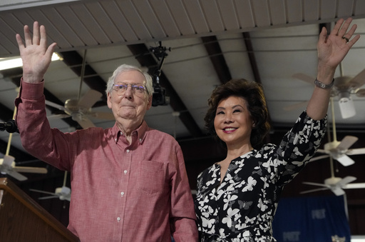 Sen. Mitch McConnell, R-Ky., left, and his wife, Elaine Chao, wave to the crowd at the annual Fancy Farm picnic Saturday, Aug. 2, 2025, in Fancy Farm, Ky. (AP Photo/Mark Humphrey)
