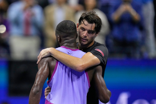 FILE - Taylor Fritz, of the United States, hugs Frances Tiafoe, of the United States, after winning the men's singles semifinals of the U.S. Open tennis championships, Sept. 6, 2024, in New York. (AP Photo/Kirsty Wigglesworth, file)