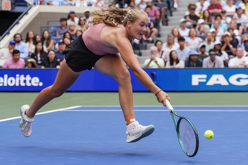 Mirra Andreeva returns a shot during a mixed doubles match at the U.S. Open tennis championships, Tuesday, Aug. 19, 2025, in New York. (AP Photo/Yuki Iwamura)