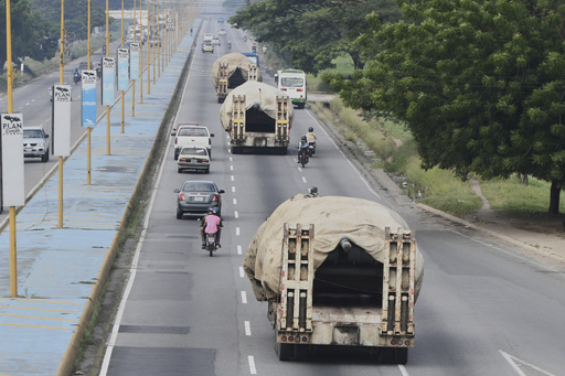 Trucks transport tanks east from Valencia, Venezuela, Wednesday, Aug. 27, 2025, after the government announced a military mobilization following the U.S. deployment of warships off Venezuela. (AP Photo/Jacinto Oliveros)