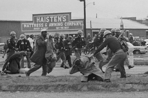 FILE - State troopers swing billy clubs to break up a civil rights voting march in Selma, Ala., March 7, 1965. (AP Photo, File)