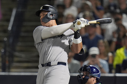 New York Yankees' Aaron Judge watches his solo home run off Tampa Bay Rays pitcher Shane Baz during the first inning of a baseball game Tuesday, Aug. 19, 2025, in Tampa, Fla. (AP Photo/Chris O'Meara)