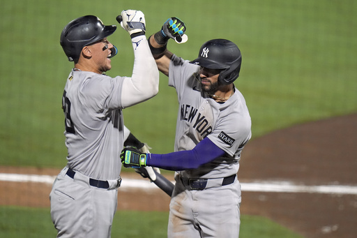 New York Yankees' José Caballero, right, celebrates his home run off Tampa Bay Rays pitcher Mason Montgomery with Aaron Judge during the ninth inning of a baseball game Wednesday, Aug. 20, 2025, in Tampa, Fla. (AP Photo/Chris O'Meara)