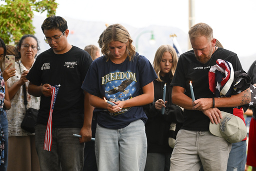 People attend a vigil at Timpanogos Regional Hospital for Charlie Kirk, the CEO and co-founder of Turning Point USA who was shot and killed, on Wednesday, Sept. 10, 2025, in Orem, Utah. (AP Photo/Alex Goodlett)