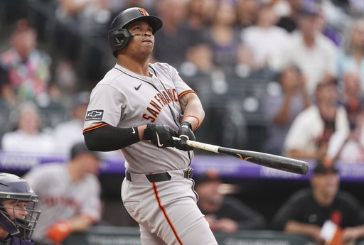 San Francisco Giants' Rafael Devers follows the flight of his two-run home run off Colorado Rockies starting pitcher Kyle Freeland in the first inning of a baseball game Tuesday, Sept. 2, 2025, in Denver. (AP Photo/David Zalubowski)