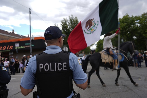 Police watch during the 2025 Pilsen Mexican Independence Day parade Saturday, Sept. 6, 2025, in Chicago. (AP Photo/Carolyn Kaster)