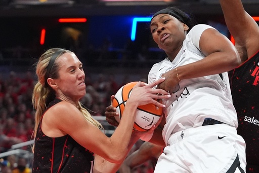 Las Vegas Aces' NaLyssa Smith, right, is tied up by Indiana Fever's Lexie Hull during first half of Game 3 of a WNBA basketball playoff semifinals series, Friday, Sept. 26, 2025, in Indianapolis. (AP Photo/Darron Cummings)