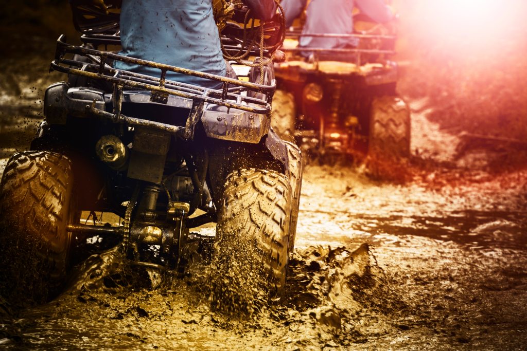 man riding atv vehicle on off road track