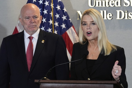 Attorney General Pam Bondi speaks as U.S. Attorney of Middle District of Florida Gregory W. Kehoe, left, watches during a human smuggling news conference Thursday Sept. 4, 2025, in Tampa, Fla. (AP Photo/Chris O'Meara)