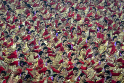Assamese dancers in traditional attire perform as they attempt Guinness World Record in the largest folk dance performance category in Guwahati, India, Friday, April 14, 2023. Around 11,000 Bihu dancers and musicians performed together to set a new record for Guinness World Record in the largest folk dance performance category today. (AP Photo/Anupam Nath)