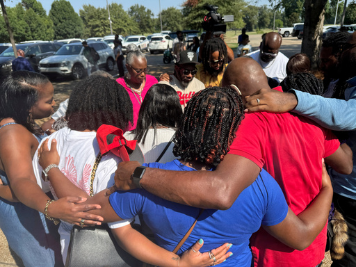 Friends and family of a deceased Delta State University student gather outside to pray after a law enforcement briefing, Wednesday, Sept. 17, 2025, in Cleveland, Miss. (AP Photo/Sophie Bates)