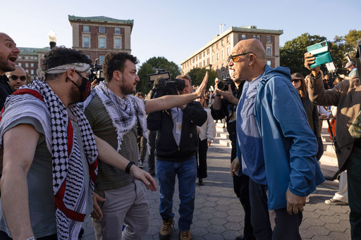 FILE - Pro-Palestinian demonstrator Mahmoud Khalil, second from left, debates with a pro-Israel demonstrator during a protest at Columbia University, Oct. 12, 2023, in New York. (AP Photo/Yuki Iwamura, file)