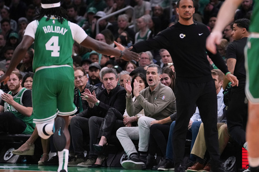 FILE - Boston Celtics owner Bill Chisholm, seated right, applauds during the first half in game 2 of a first-round NBA playoff basketball series against the Orlando Magic, April 23, 2025, in Boston. (AP Photo/Charles Krupa, File)