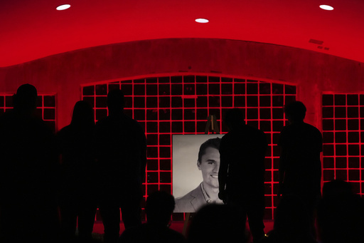 People pay their respects during a vigil for Charlie Kirk, the CEO and co-founder of Turning Point USA who was shot and killed, Thursday, Sept. 11, 2025, in Orem, Utah. (AP Photo/Lindsey Wasson)