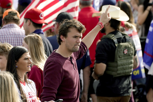 FILE - Charlie Kirk, conservative activist and founder of Turning Point USA, walks through the crowd at a pro Trump rally outside the Maricopa County Recorder's Office where elections officials continue to count ballots, Friday, Nov. 6, 2020, in Phoenix. (AP Photo/Matt York, File)