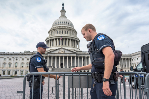 Capitol Police officers adjust security barriers around the East Plaza at the Capitol in Washington, Wednesday, Sept. 24, 2025. With just days to go before federal money runs out with the end of the fiscal year on Tuesday, Sept. 30, Congress has failed to pass legislation to keep the government running after becoming deadlocked during votes late last week. (AP Photo/J. Scott Applewhite)