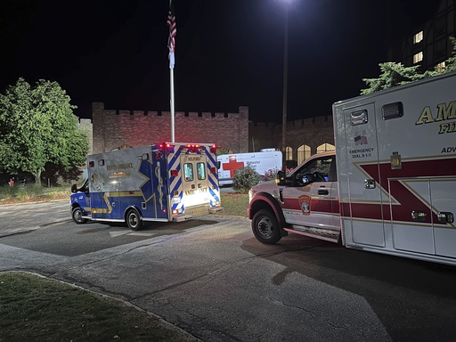 Ambulances are parked outside a hotel that is acting as a reunification center after a shooting at a country club in Nashua, New Hampshire, Saturday, Sept. 20, 2025. (AP Photo/Michael Casey)