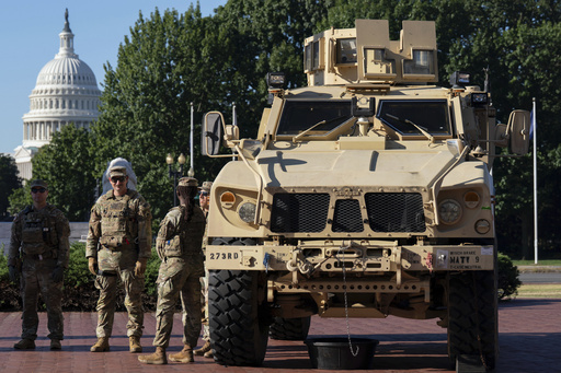 Members of the District of Columbia National Guard standing next to an MATV vehicle scan the area as they patrol outside Union Station, Monday, Sept. 1, 2025, in Washington. (AP Photo/Jose Luis Magana)