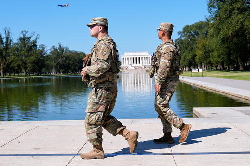 Members of the South Carolina National Guard patrol with the Lincoln Monument in the background, Friday, Sept. 5, 2025, in Washington. (AP Photo/Mariam Zuhaib)
