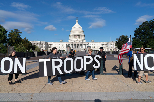 Demonstrators protest against President Donald Trump's use of federal law enforcement and National Guard troops in the city during a protest at the U.S. Capitol, Tuesday, Sept. 2, 2025, in Washington. (AP Photo/Jose Luis Magana)