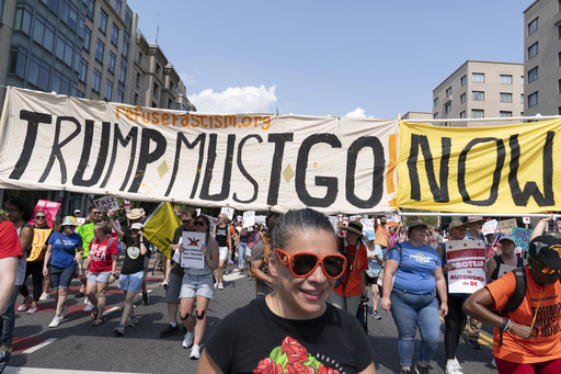 Demonstrators protest against President Donald Trump's deployment of federal law enforcement and National Guard troops in Washington during a march on Saturday, Sept. 6, 2025. (AP Photo/Jose Luis Magana)
