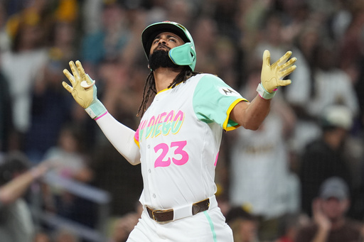 San Diego Padres' Fernando Tatis Jr. celebrates after hitting a grand slam during the fourth inning of a baseball game against the Arizona Diamondbacks Friday, Sept. 26, 2025, in San Diego. (AP Photo/Gregory Bull)
