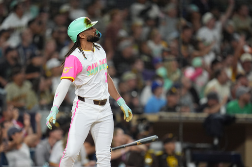 San Diego Padres' Fernando Tatis Jr. watches his grand slam during the fourth inning of a baseball game against the Arizona Diamondbacks Friday, Sept. 26, 2025, in San Diego. (AP Photo/Gregory Bull)