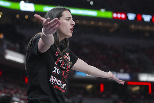 Indiana Fever guard Caitlin Clark (22) gestures on the bench in the first half of a WNBA basketball playoff game between the Indiana Fever and the Atlanta Dream in Indianapolis, Tuesday, Sept. 16, 2025. (AP Photo/Michael Conroy)