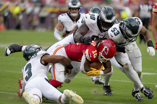 Kansas City Chiefs running back Isiah Pacheco (10) is tackled by Philadelphia Eagles' Nolan Smith (3), Jordan Davis (90) and Zack Baun (53) during the second half of an NFL football game Sunday, Sept. 14, 2025, in Kansas City, Mo. (AP Photo/Ed Zurga)