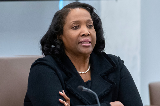 FILE - Federal Reserve Board of Governors member Lisa Cook listens during an open meeting of the Board of Governors at the Federal Reserve, June 25, 2025, in Washington. (AP Photo/Mark Schiefelbein, File)