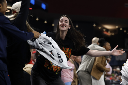Indiana Fever guard Caitlin Clark, center, reacts after a score to take the lead over the Atlanta Dream during the second half of Game 3 in the first round of the WNBA basketball playoffs, Thursday, Sept. 18, 2025, in Atlanta. (AP Photo/Butch Dill)
