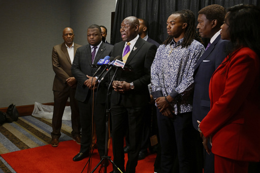 FILE - William McNeil Jr., third from right, looks on while his attorney Ben Crump, center, speaks during a press conference Tuesday, July 29, 2025, in Chicago. (AP Photo/Paul Beaty, File)
