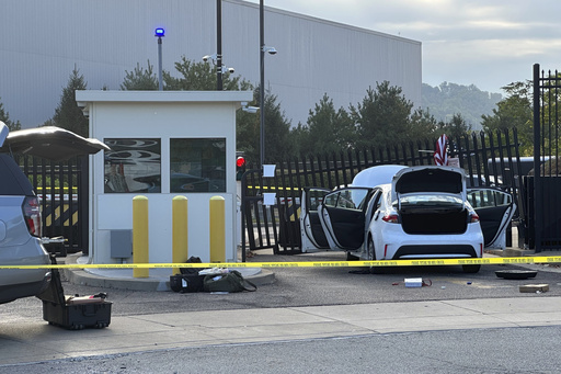 FBI officials inspect a car that rammed into a gate at the FBI building in Pittsburgh, Wednesday, Sept. 17, 2025. (AP Photo/Peter Smith)